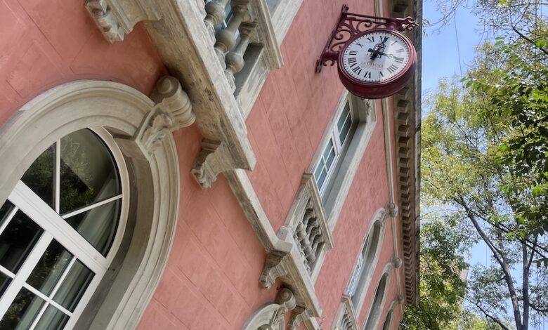 Original facade in original salmon color with original red clock from 1960s.jpg